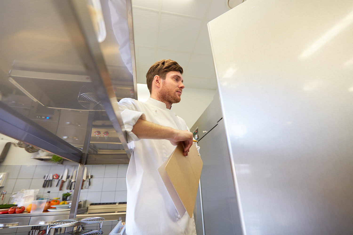 Chef preparing sandwich on a prep table 